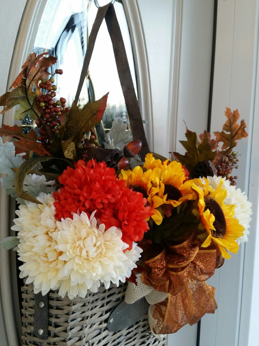 It has a small tin welcome sign on the front of the basket. Strap is leather ~